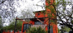 a building with an orange at Casita Naranja in La Calera