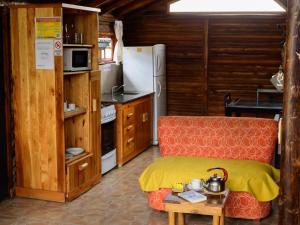 a kitchen with a couch and a refrigerator and a table at Aventurados in Potrerillos