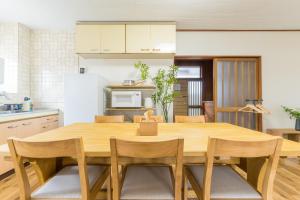a kitchen with a wooden table and chairs at オオジンマチ ハイツ303 in Takayama