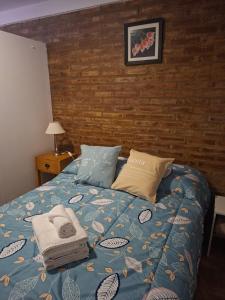 a bedroom with a blue bed with towels on it at Barrio Aeropuerto 1 in RSA