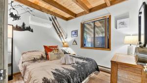 a bedroom with a bed and a desk and a window at Bear Cabin Hideout in Hamlin
