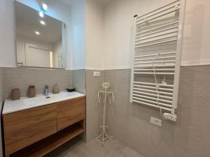 a bathroom with a sink and a mirror at Loft Nineteen Apartment in La Spezia +17 photos
