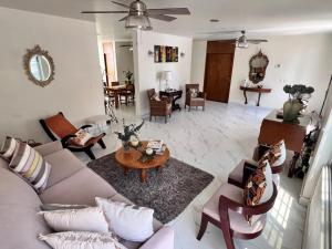 a living room with a couch and a table at Hosteleria Casa Margarita in Mazatlán