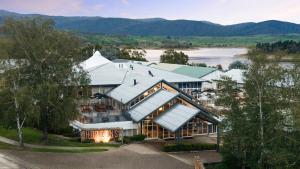 an aerial view of a large building with a lake at Horizons Lake Jindabyne in Jindabyne