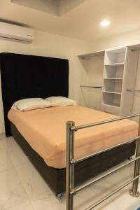a bedroom with a bed with a black headboard at Urban Loft Hotel Federalismo in Guadalajara +30 photos