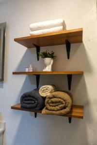 a wooden shelf with towels on a wall at Urban Loft Hotel Federalismo in Guadalajara