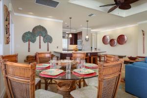 a dining room and kitchen with a table and chairs at Beautiful Ocean Villa in Kawela