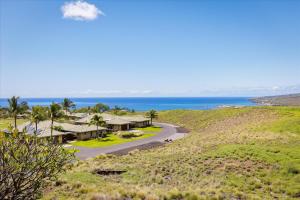 an aerial view of a house on a hill next to the ocean at Beautiful Ocean Villa in Kawela