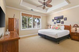 a bedroom with a bed and a ceiling fan at Beautiful Ocean Villa in Kawela +46 photos