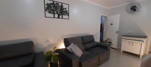a living room with a couch and a chair at Aluguel Piratuba, apto 104 Dambros in Piratuba