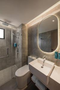 a bathroom with a sink and a toilet and a mirror at Oakwood Cameron Highlands in Cameron Highlands +29 photos