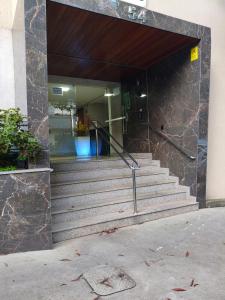 a building with stairs in front of a building at 950 metros da UFV apartamento e ao lado da prefeitura in Viçosa