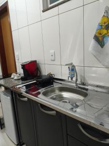 a kitchen with a sink and a counter top at 950 metros da UFV apartamento e ao lado da prefeitura in Viçosa
