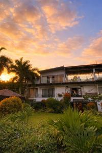 a building with palm trees in front of a sunset at Amega Hotel in Tagaytay +22 photos