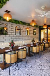 a restaurant with tables and chairs in a room at Amega Hotel in Tagaytay