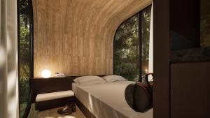 a bedroom with a bed and a window at WANDER Cabins Villa Alpina in Villa Alpina
