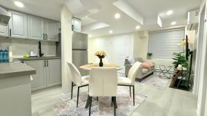 a kitchen and dining room with a table and chairs at Modern 2BR Suite Private Entrance Parking New in Woodstock