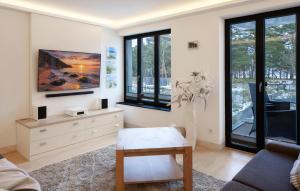 a living room with a couch and a table and windows at Junior in Binz