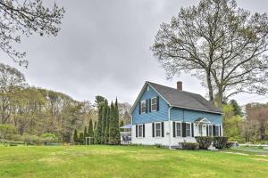 a blue and white house on a grass field at Relaxing Getaway Near Everything in Kennebunk