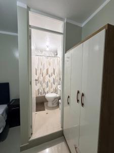 a bathroom with a shower and a toilet in it at Estancia La Luna in Huarmey