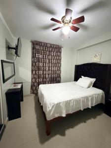a bedroom with a ceiling fan and a bed at Estancia La Luna in Huarmey +16 photos