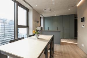 an office with a long table with flowers on it at ASTY Cabin Seoul Serviced Residence in Seoul +95 photos