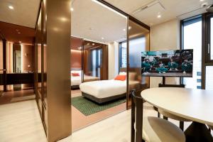 a hotel room with a bed and a table at ASTY Cabin Seoul Serviced Residence in Seoul