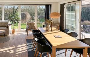 a dining room with a wooden table and chairs at 3 Bedroom Cozy Home In Haderslev in Haderslev
