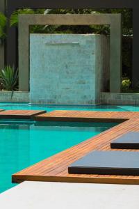 a swimming pool with a wooden deck and a swimming pool at Pousada Villorba in Socorro +22 photos