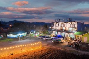 a large building with cars parked in a parking lot at Silver Glowing Sea Pension in Taean