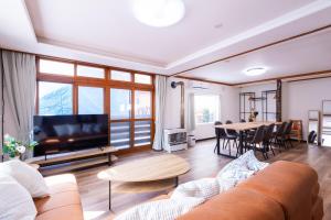 a living room with a couch and a table at Villa Blanca Yoichi in Yoichi