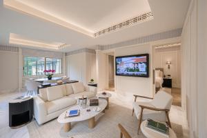 a living room with a couch and a tv at METT Singapore in Singapore