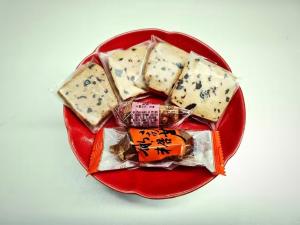 a plate of cheese on a red plate at Beijing Pudi Hotel in Beijing