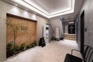 a lobby with a door with a tree on it at Dongdaemun Stay Garden in Seoul