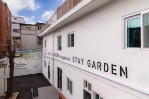 a white building with a sign that reads stay garden at Dongdaemun Stay Garden in Seoul