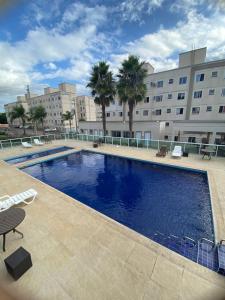 a large swimming pool in front of a building at Comfortable, well-located, renovated apartment in São Leopoldo