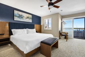 a bedroom with a large bed with a ceiling fan at 456 Embarcadero Inn & Suites in Morro Bay +98 photos