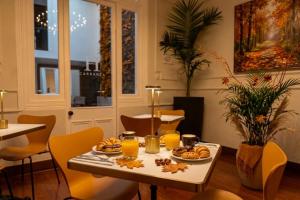 a table with orange juice and food on it at H Ocaranza in Santiago