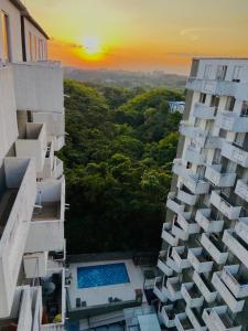 an aerial view of buildings with a sunset in the background at Apartaestudio vacacional in Armenia