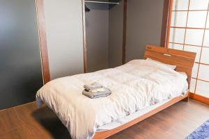 a bedroom with a bed with a mirror on it at Udo Torii Gate Stay Yoi in Nichinan