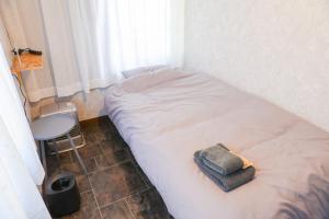 a small bed in a room with a small table at Udo Torii Gate Stay Yoi in Nichinan +11 photos