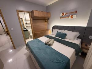 a bedroom with a large bed with a blue blanket at Lençois Confort in Barreirinhas +34 photos