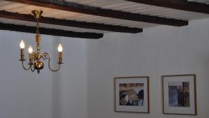 a chandelier hanging from a ceiling in a room at Chalet Goldblick in Grächen