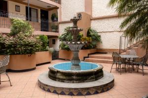 a fountain in the middle of a courtyard at Hotel San Angel in Puebla