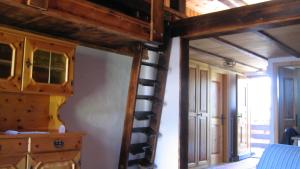 a room with a spiral staircase in a house at Chalet Goldblick in Grächen