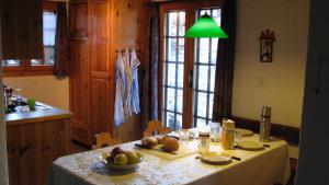 a kitchen with a table with a bowl of fruit on it at Chalet Goldblick in Grächen
