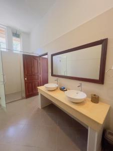 a bathroom with two sinks and a large mirror at Terrace Resort in Phú Quốc
