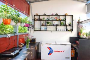 a room with plants on shelves on the wall at The Son Villa Hội An in Danang
