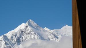 a snow covered mountain with a blue sky at Chalet Goldblick in Grächen