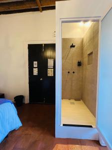 a bathroom with a shower with a glass door at Mansion Von Humboldt in Guanajuato